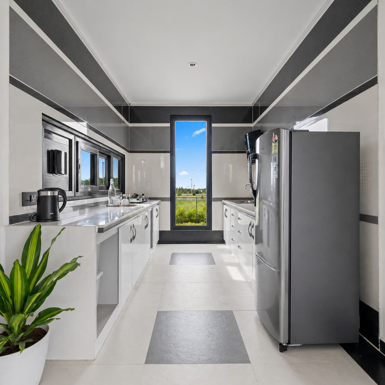 Galley kitchen with marble counters, full appliances and narrow garden window